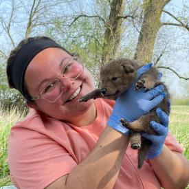 Abby holding coyote pup
