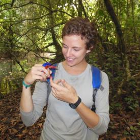 Courtney holding a kingfisher in the woods